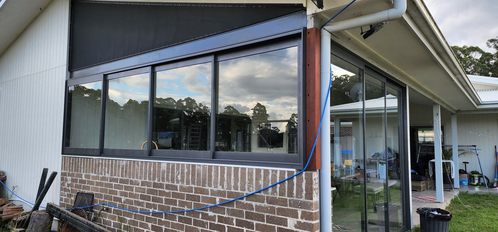 Frameless glass fitted to a brick home