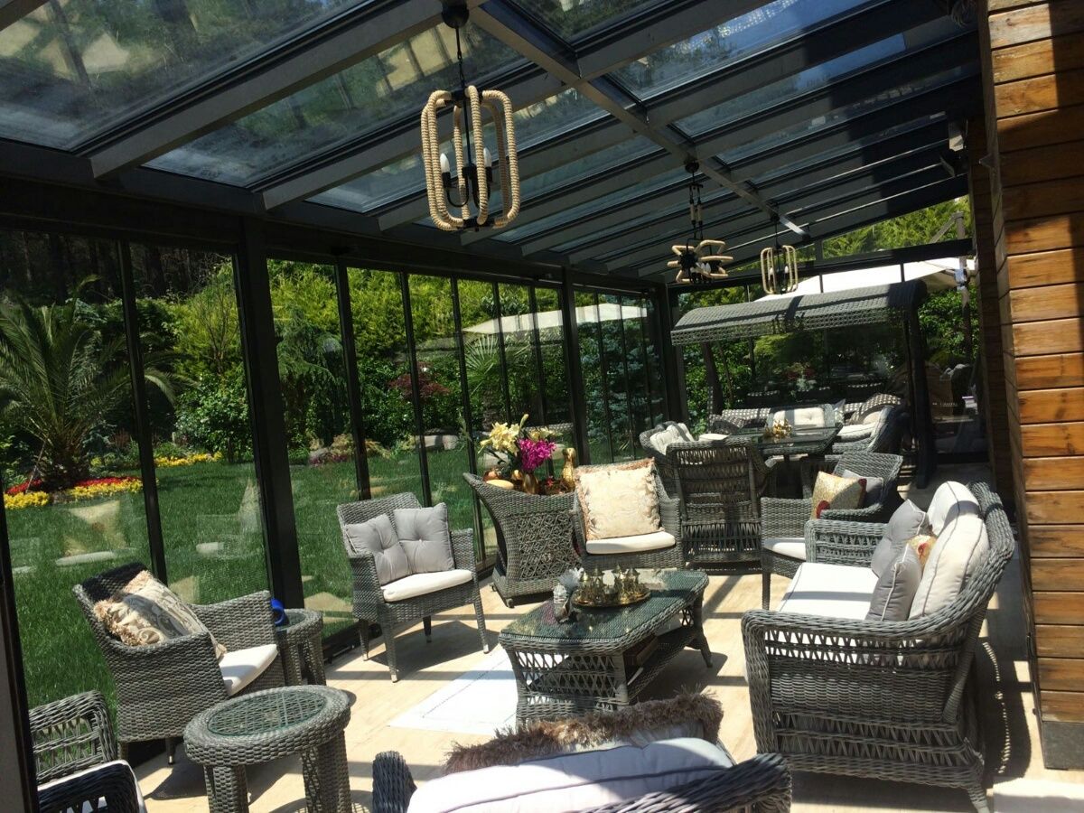 Glazed outdoor lounge under a glass roof