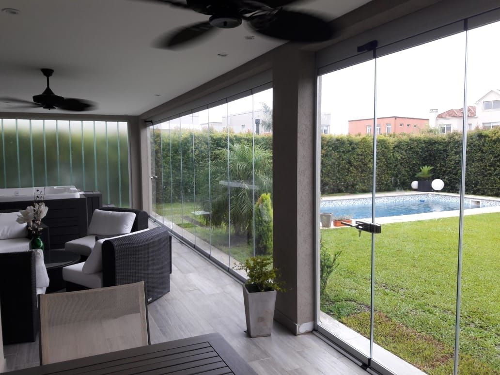 Enclosed terrace beside a pool